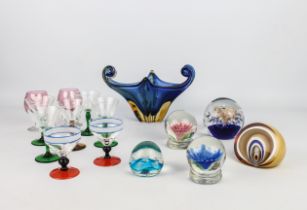 A small group of coloured glass and paperweights