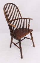 An early 19th century beech and elm hoop back Windsor arm chair - the high stick back over curved