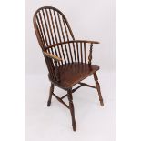 An early 19th century beech and elm hoop back Windsor arm chair - the high stick back over curved