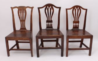 A matched pair of George III provincial dining chairs - one in oak, beech and fruitwood, the other