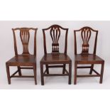 A matched pair of George III provincial dining chairs - one in oak, beech and fruitwood, the other