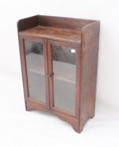 Two pieces: a small 1930s oak glazed bookcase - with open shelf top over a pair of glazed doors