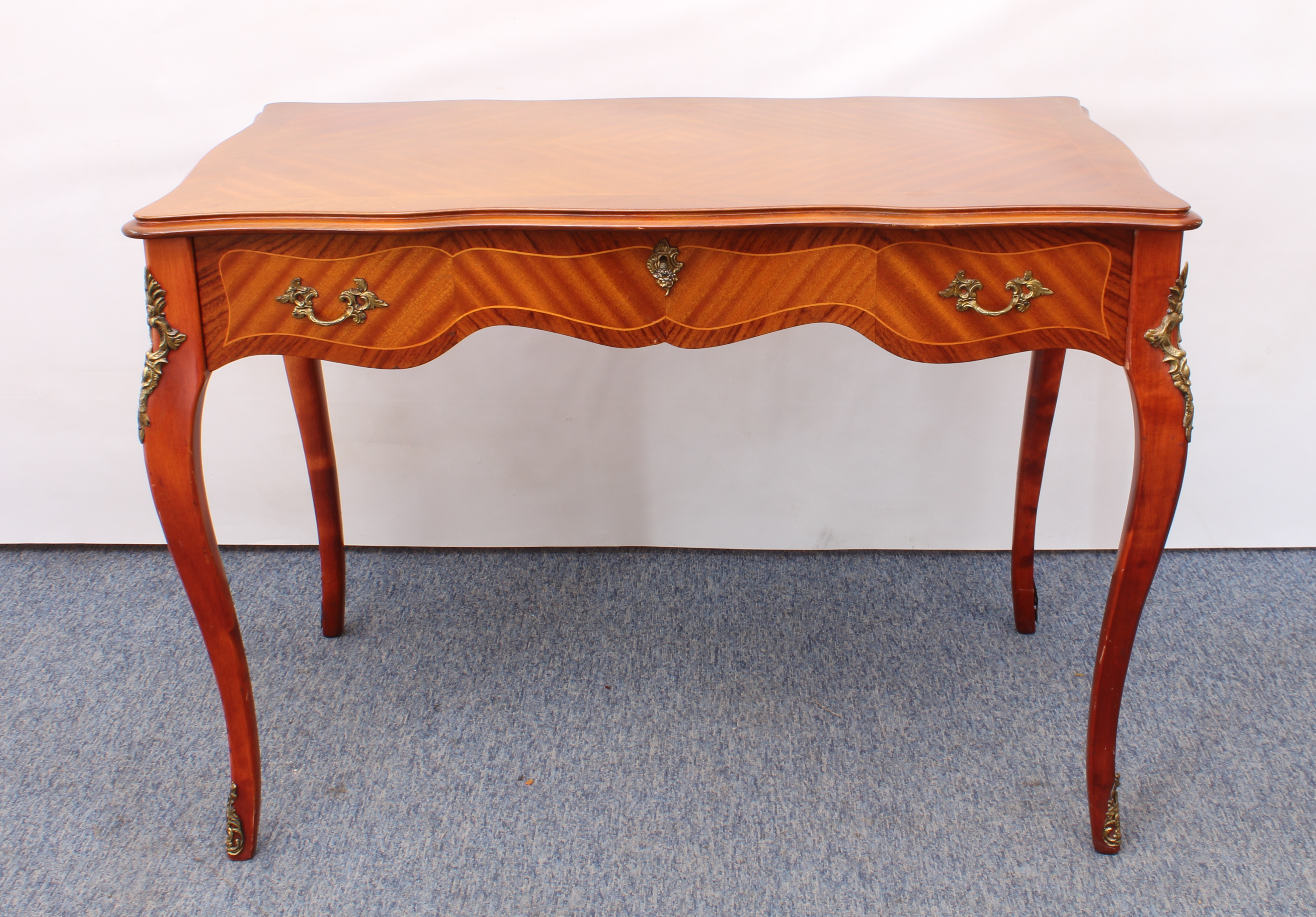 Two pieces: 1. a reproduction French 19th century style mahogany and kingwood serpentine writing