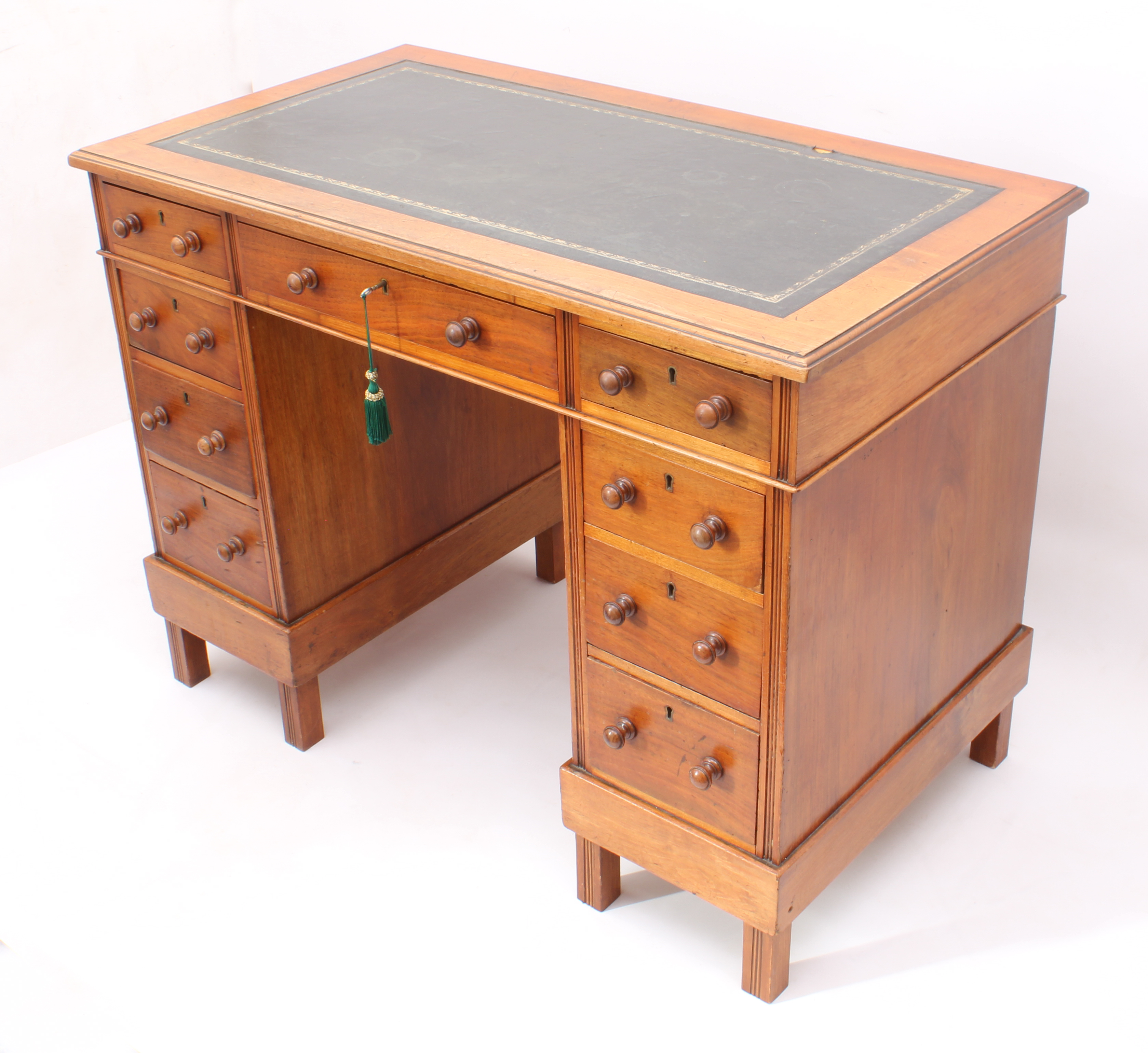 An Edwardian walnut double pedestal desk - the moulded top with inset gilt tooled green leather,