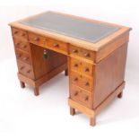 An Edwardian walnut double pedestal desk - the moulded top with inset gilt tooled green leather,