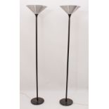 A pair of modern black and brushed aluminium uplighters - 173.5 cm high, the circular bases on