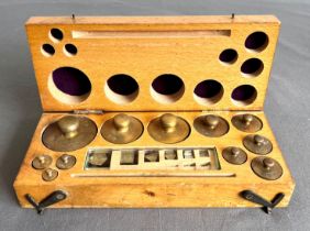 A cased set of scientific brass and foil weights - from 2mg to 200grm, in a fitted beech wood