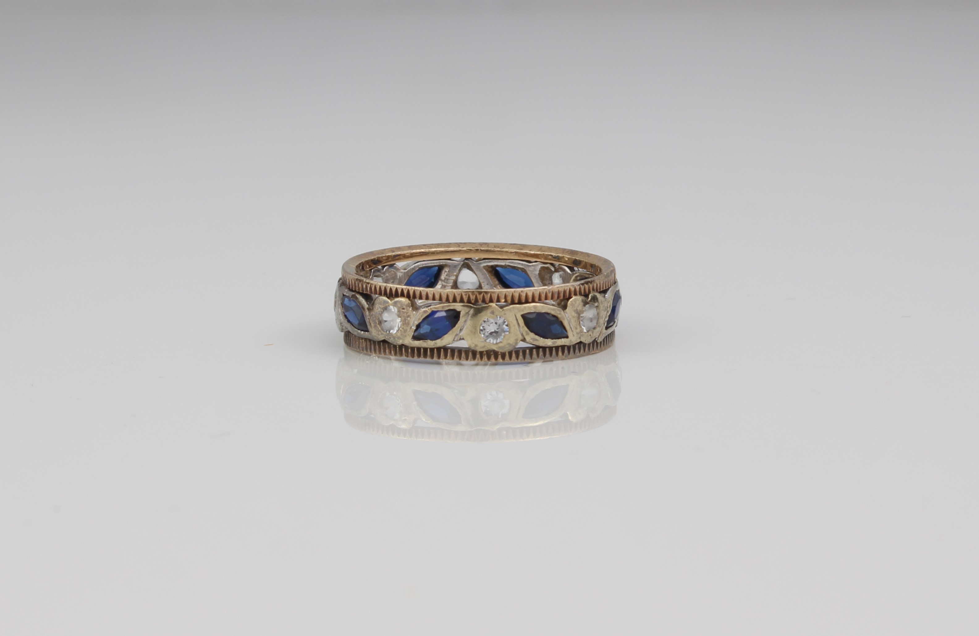 A 9ct gold two-colour sapphire eternity ring.