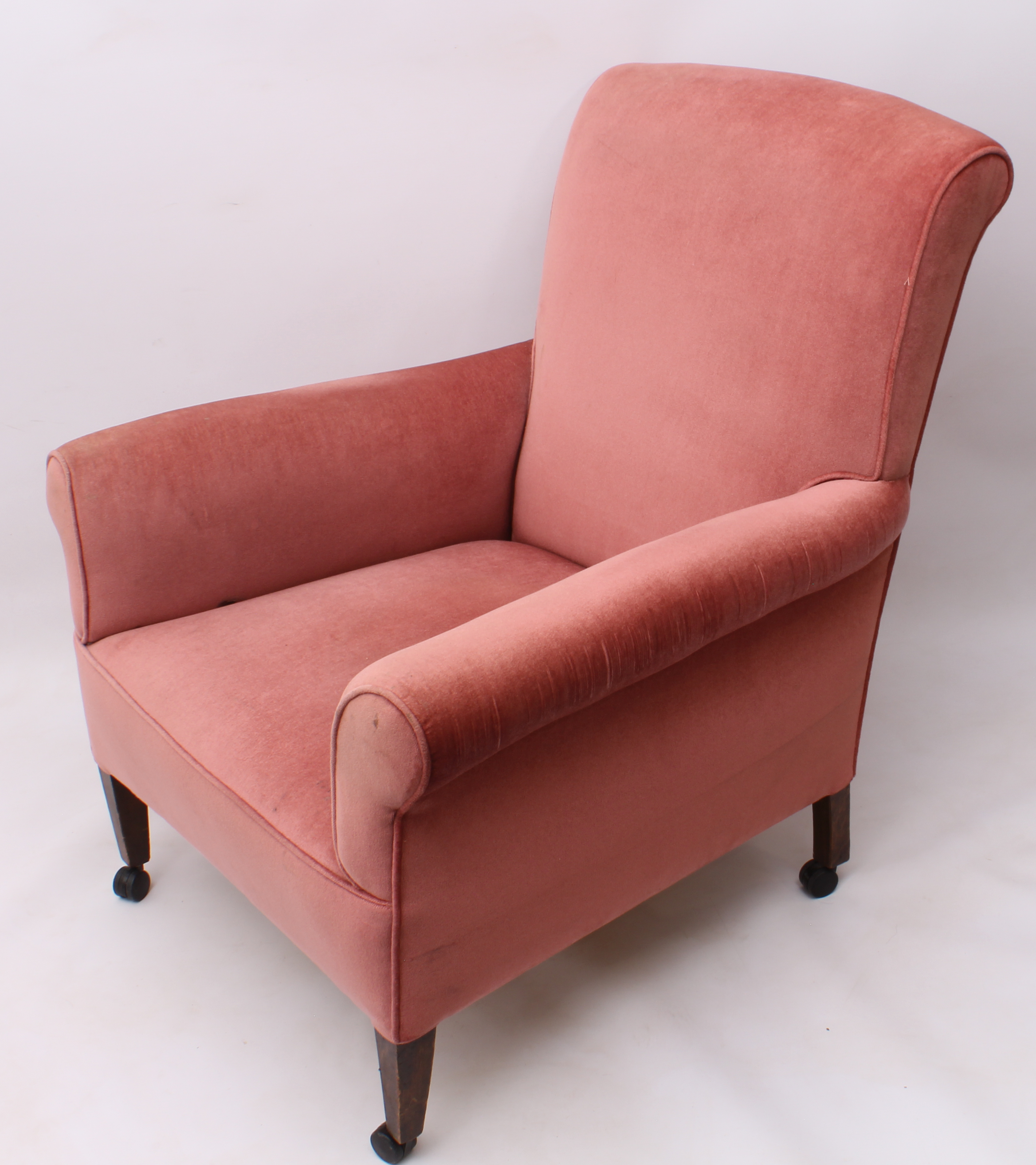 An early 20th century armchair - upholstered in pink velour, with square tapered beechwood legs