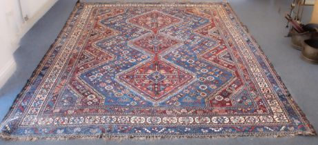A large Persian Heriz rug - probably early 20th century, the three madder pole medallions with