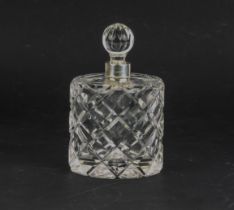 A crystal scent bottle with a silver top.