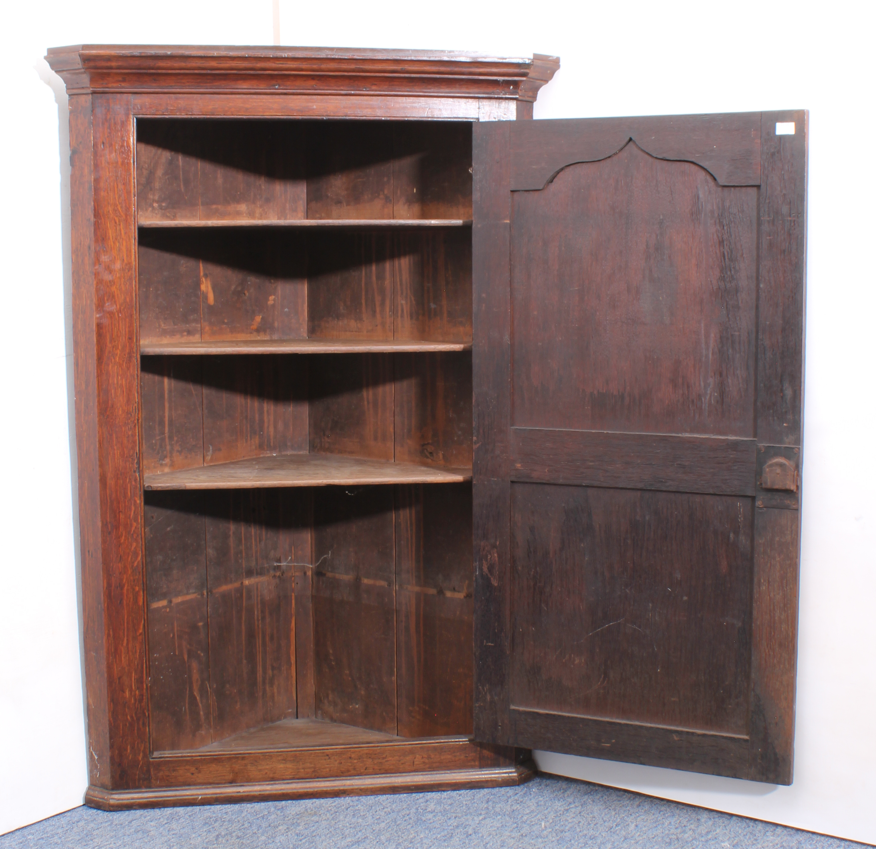 A large George III oak wall-hanging corner cupboard - the ogee moulded cornice over a two chamfer- - Image 2 of 3