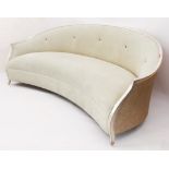 A crescent-shaped silvered giltwood, caned and suede settee by Christopher Guy - reputedly