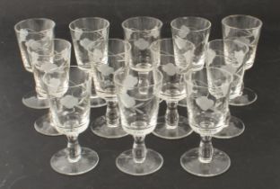 A set of twelve port glasses - 1950s-60s, the bucket bowls wheel-engraved with trailing flowers,