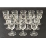 A set of twelve port glasses - 1950s-60s, the bucket bowls wheel-engraved with trailing flowers,