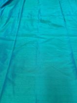 A pair of handmade curtains in vibrant sea-green faux silk; interlined and lined in cream cotton