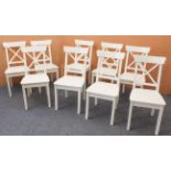 A set of nine Ikea 'Ingolf' white-painted dining chairs - with X-shaped backs and solid seats, on