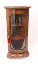 A small glazed walnut stained bowfront corner cabinet - late 20th century, with electric