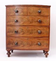 A Victorian mahogany bowfronted chest of drawers - with two short over three long graduated flame