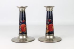 A good pair of William Moorcroft for Liberty & Co. Tudric candlesticks - in the 'Pomegranate'