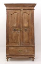 An Indian panelled hardwood cupboard - mid-20th century, probably teak, the flared, moulded