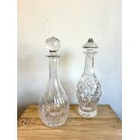 Two Waterford cut-glass decanters with etched factory marks: 1. Mallet-shaped, with diamond cut
