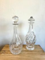 Two Waterford cut-glass decanters with etched factory marks: 1. Mallet-shaped, with diamond cut