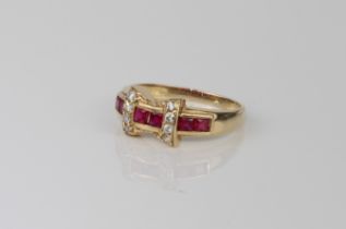 A 14ct yellow gold, red and white stone ring - stamped 'AK 14K', with a central bowtie cluster