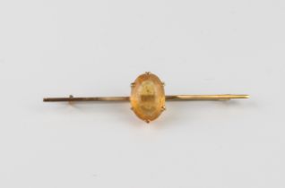 A vintage 9ct gold and citrine bar brooch - stamped '9CT', with an oval cut 14 x 9mm citrine, 57mm