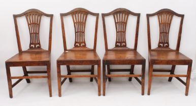 A set of four George III provincial oak dining chairs - with pierced vase splats over solid seats,