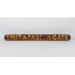 A cast iron 'Shut & Fasten Gate' railway sign - painted black with white lettering, 80.5 cm long.