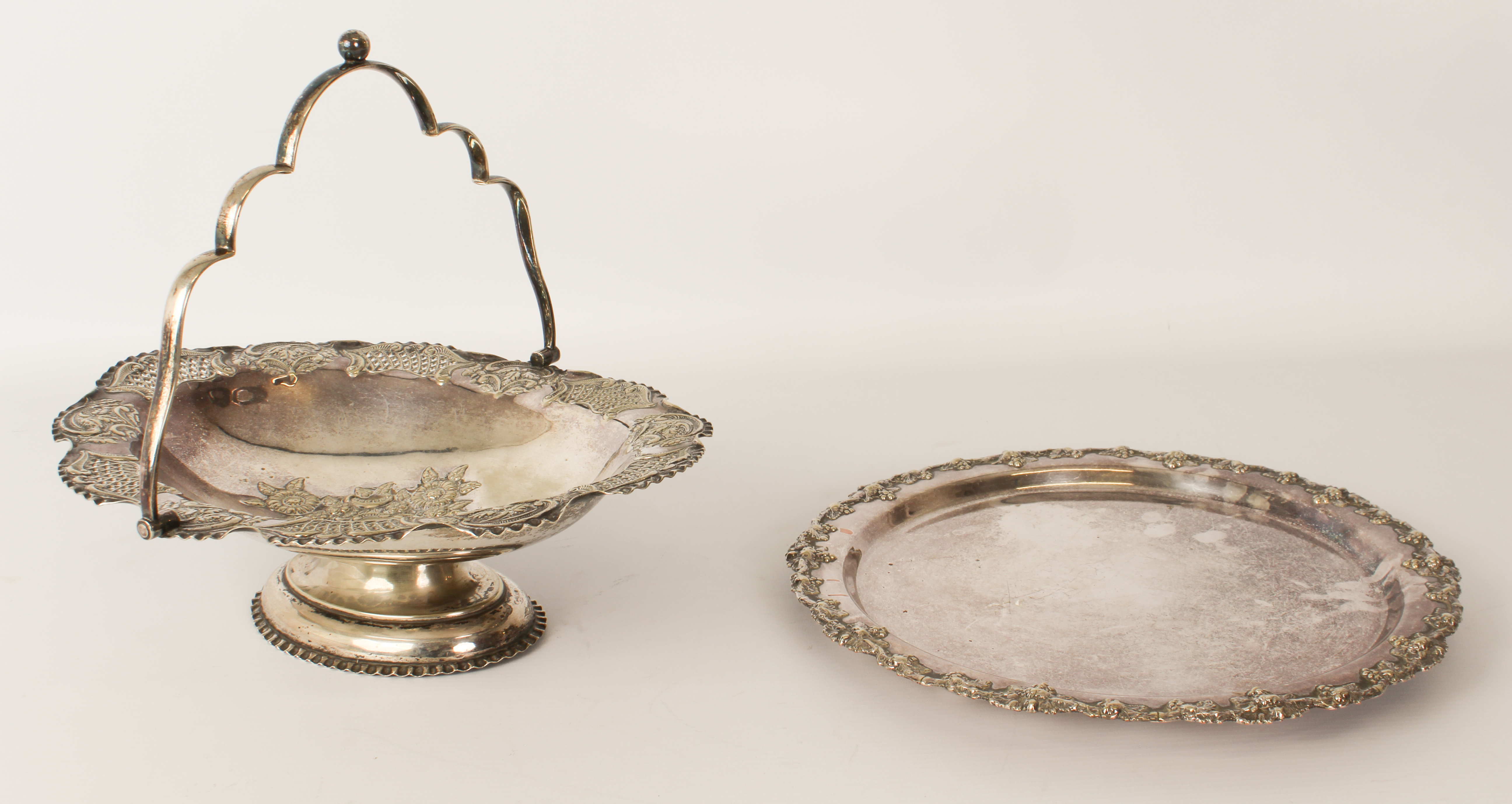 A silver-plated tray with fruiting vine border, on three bun feet (29 cm diameter) together with a