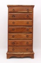 A tall teak seven-drawer chest - late 20th century, with iron ring handles and bracket feet. (LWH 57