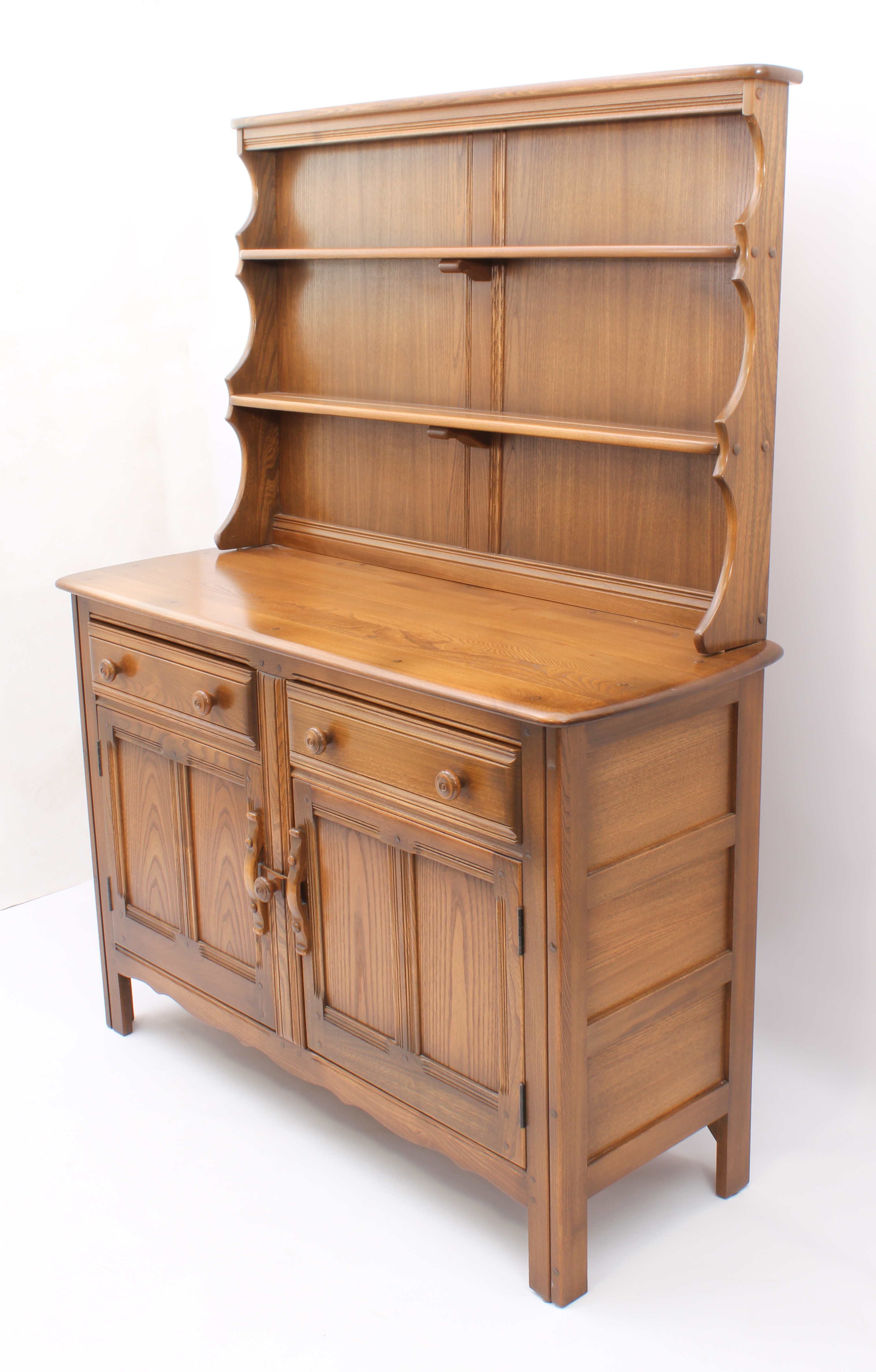 An Ercol Windsor elm dresser - the back with waterfall plate rack, over a base with two drawers (one