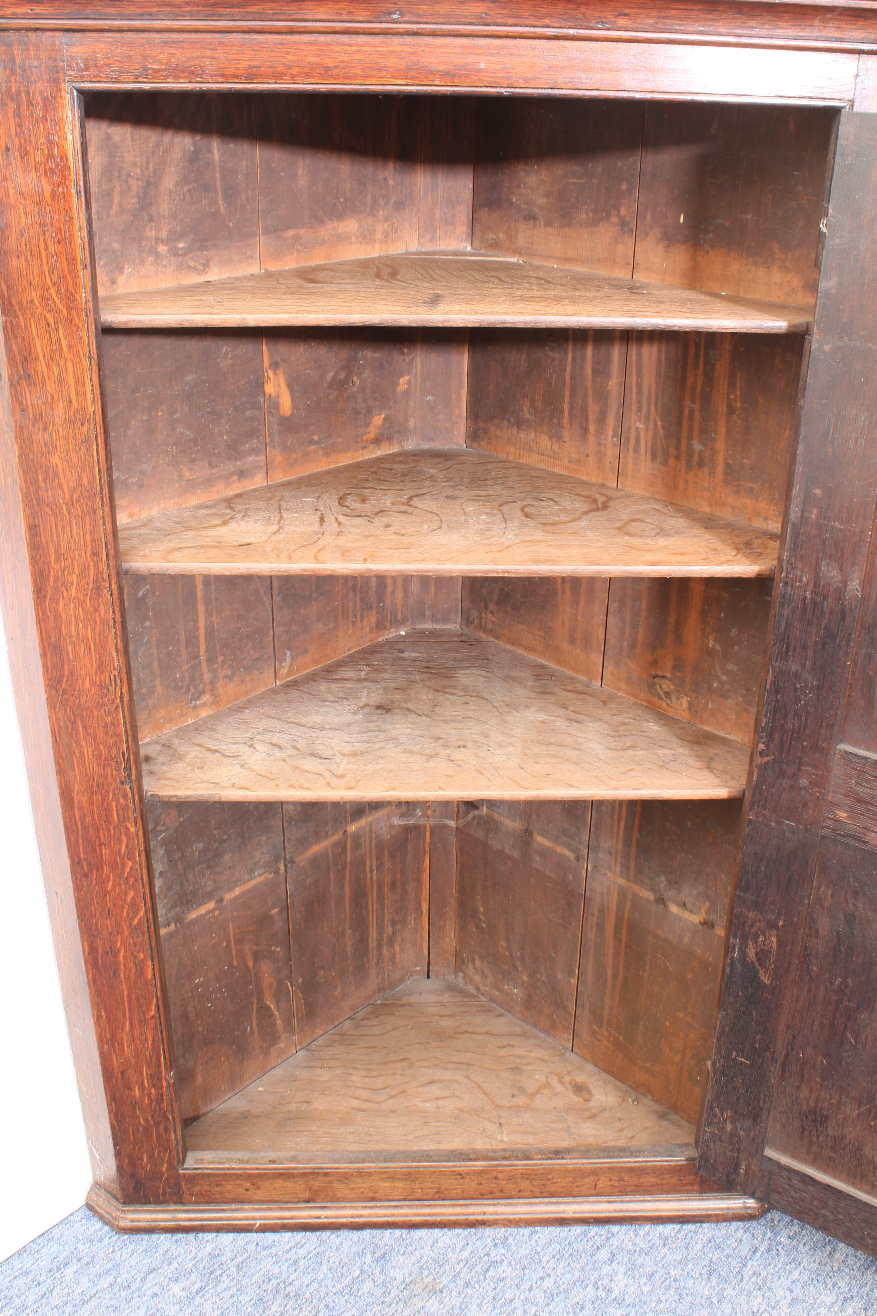 A large George III oak wall-hanging corner cupboard - the ogee moulded cornice over a two chamfer- - Image 3 of 3