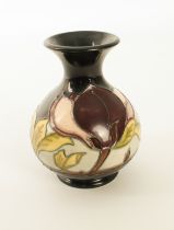 A Moorcroft baluster vase in the 'Magnolia' pattern - impressed factory and candle mark for 1992,