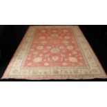 A hand knotted wool Afghan Ziegler rug - with typical all over floral decoration on a madder ground,