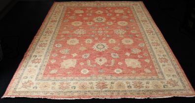 A hand knotted wool Afghan Ziegler rug - with typical all over floral decoration on a madder ground,