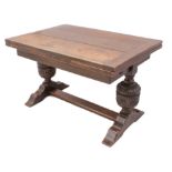 A carved oak extending refectory style dining table - the cleated, rectangular top with a single