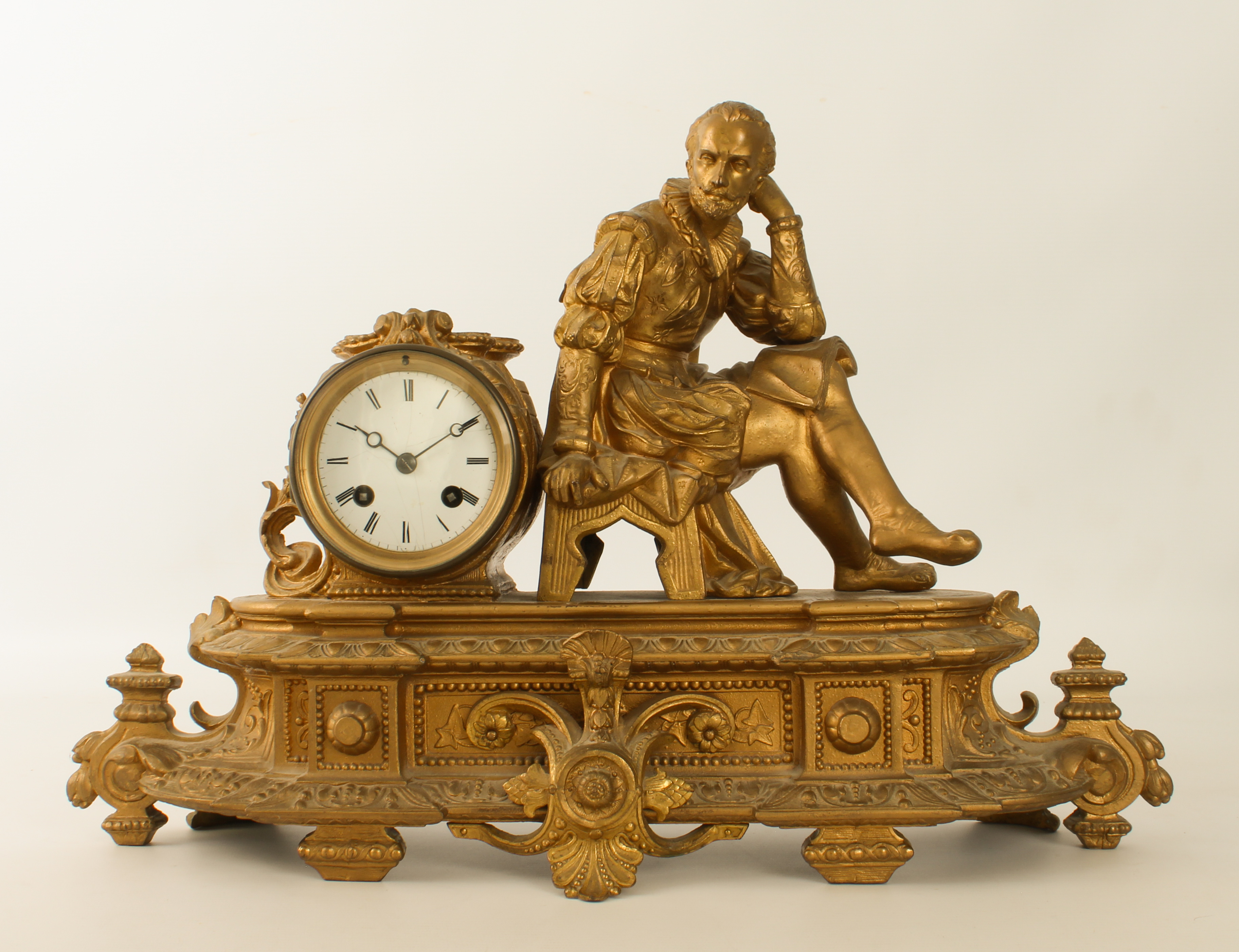 A French gilt-spelter mantel clock - early 20th century, the case with a seated figure of William