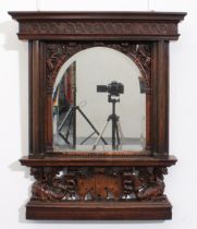 A 19th century carved oak mirror - the flared moulded cornice over a guilloche carved frieze and