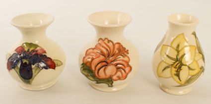 Three small ivory ground Moorcroft vases - with Walter Moorcroft designs comprising Hibiscus,