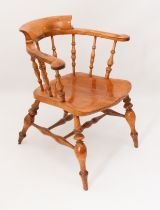 A late 19th century fruitwood and elm smoker's bow armchair - the horseshoe back with turned