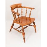 A late 19th century fruitwood and elm smoker's bow armchair - the horseshoe back with turned