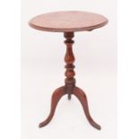 A mid-19th century mahogany tilt-top tripod table - the moulded circular top on a turned baluster