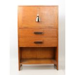 A mid-century oak miniature side cabinet - of rectangular form, the fall front over two full width