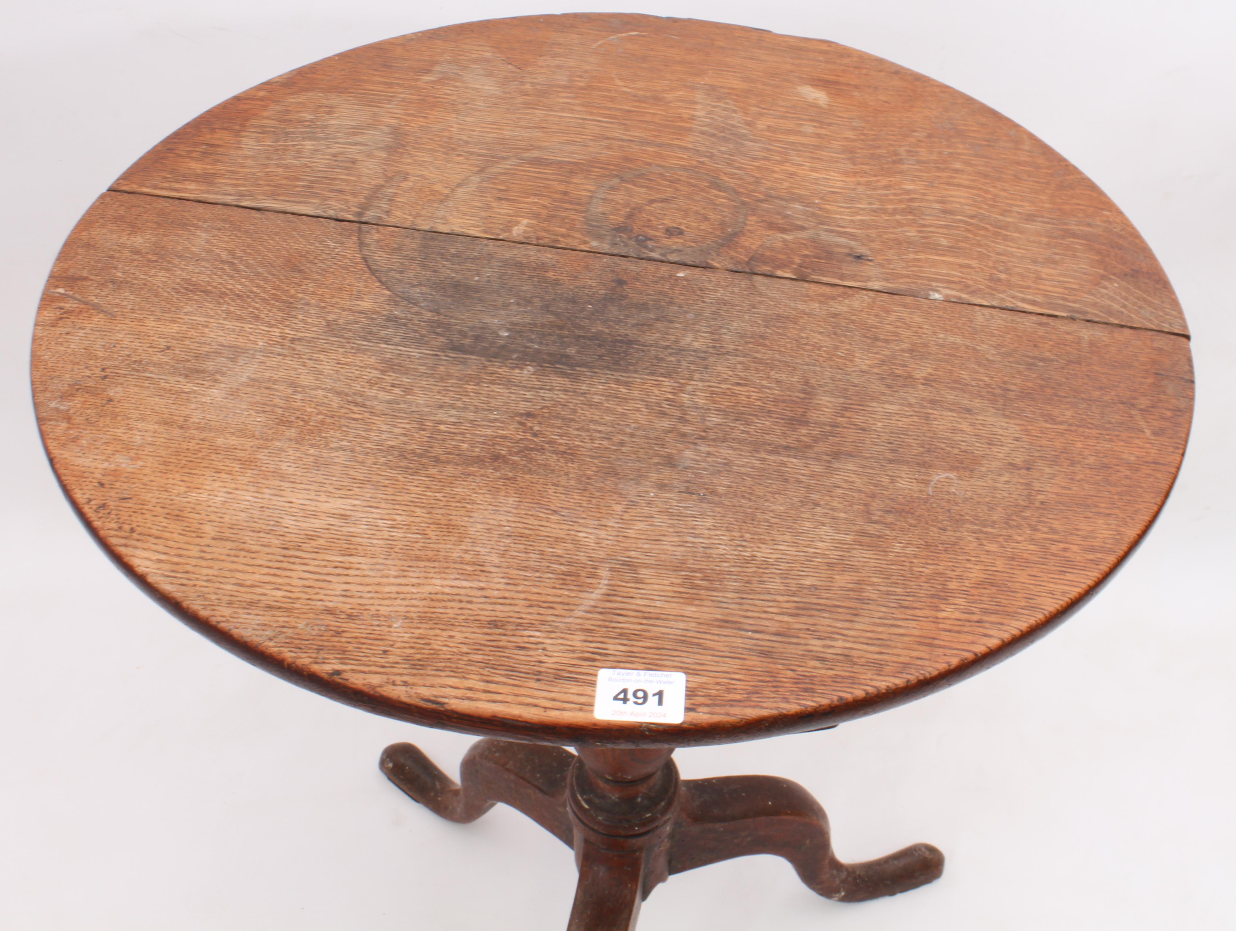 A George III oak tilt-top tripod table - the circular top on a turned baluster column to three swept - Image 2 of 2