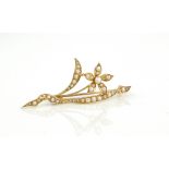 An 18ct yellow gold and seed pearl floral brooch - unmarked, tests as 18ct gold, 49mm long, one