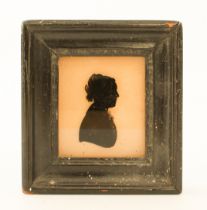 A reverse painted glass silhouette of a girl