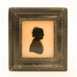 A reverse painted glass silhouette of a girl